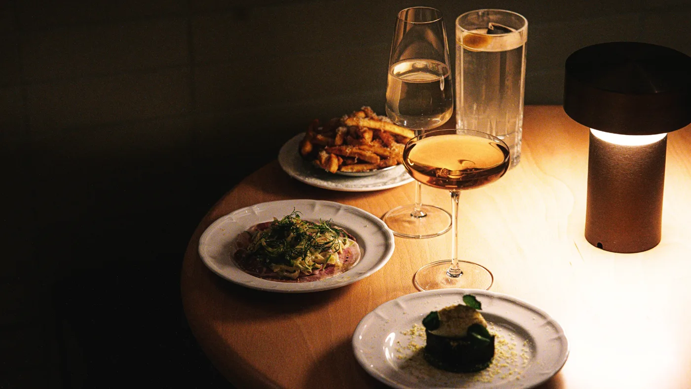 A dinner table with wine and candlelight, from the short film La Cena, original score by Santiago Bianchi