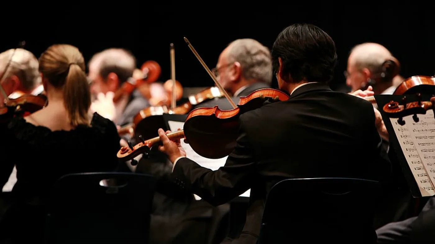 Violinists of a symphony orchestra reading their parts, operatic arrangements orchestrated by Santiago Bianchi