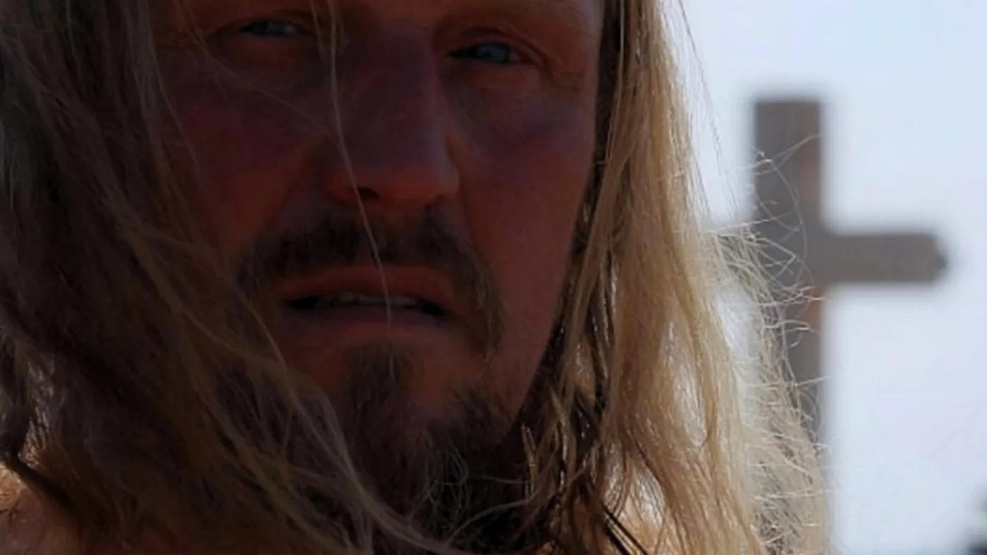 A bearded man beside a wooden cross in the short film Stations of the Cross, scored by Santiago Bianchi